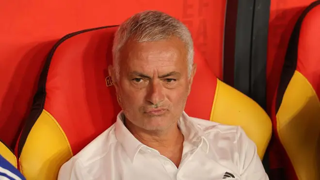 Jose Mourinho in a white T-shirt sitting in the dock