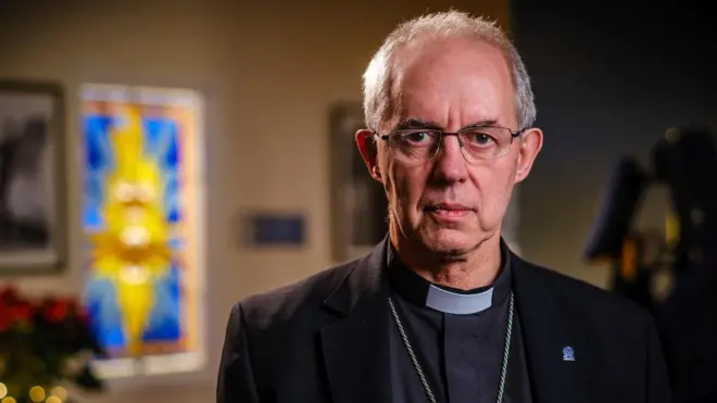 Justin Welby, wey wear glasses and get grey hair, dey look camera straight