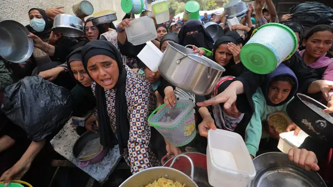 haritable organizations distribute hot meals to Palestinians in Nuseirat refugee camp, who are struggling with hunger due to Israel's attacks on Gaza and closed borders in Deir al-Balah, Gaza, on May 27, 2025. As Israel's relentless and devastating attacks on the Gaza Strip continue, Israeli policies have exacerbated the already severe humanitarian crisis in the region.
