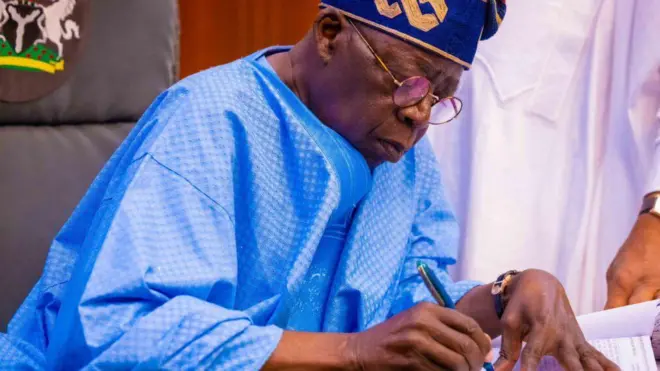 Foto of Nigeria president Bola Tinubu wen e dey sign document