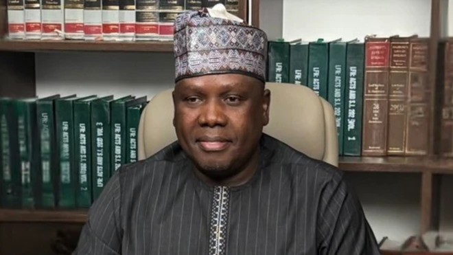 Daniel Bwala on cap wit books by im side