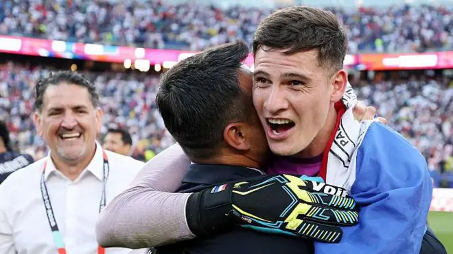 Orlando Gill hugs a member of Paraguay's team staff after they beat Germany on penalties at the 2026 World Cup