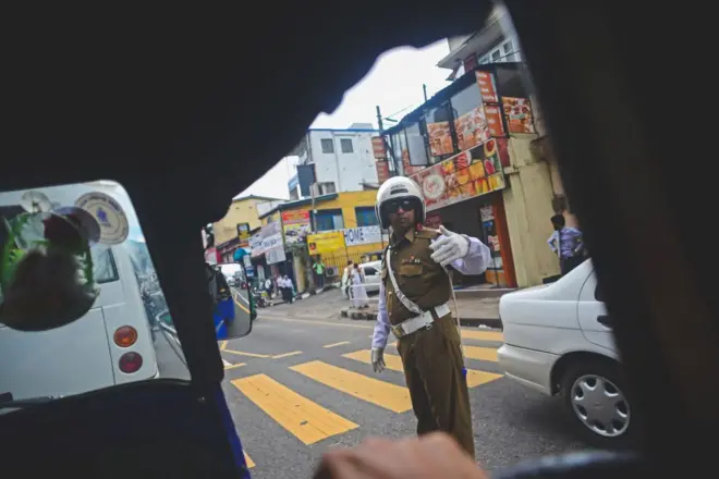 Policeman managing traffic in Kandy, view from inside a tuk tuk, Sri Lanka