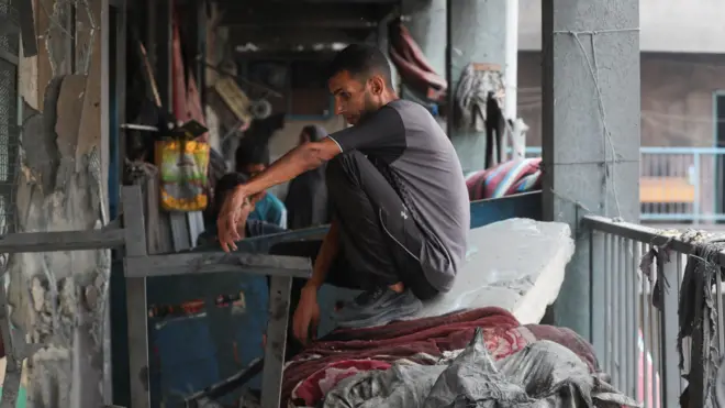 Мушкарац седи на рушевинама