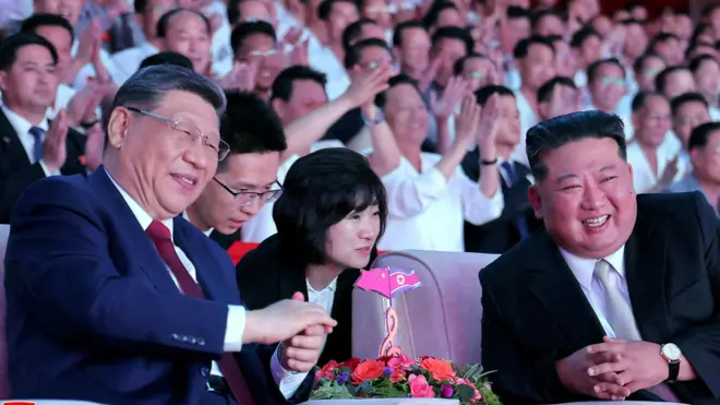 Chinese President Xi Jinping sits next to North Korean leader Kim Jong Un as he attends a performance at the Pyongyang Indoor Stadium, during his state visit, in Pyongyang, North Korea, June 8, 2026, in this picture released by North Korea's official Korean Central News Agency.