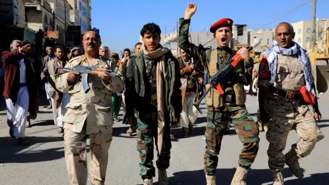Houthi fighters brandish their weapons during a march in solidarity with the Palestinian people in the Houthi-controlled capital Sanaa