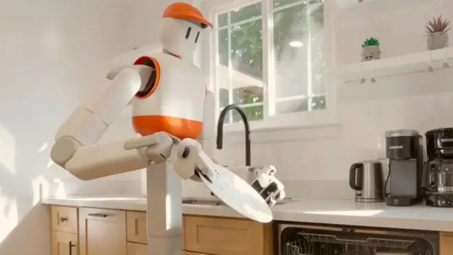 Sunday AI's Memo robot holds a plate in the kitchen and prepares to place it in the dishwasher
