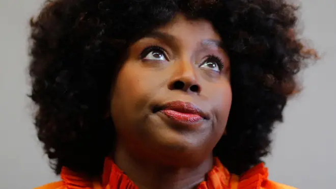 Head and shoulders portrait of popular Nigerian author Chimamanda Ngozi Adichie looking slightly left of camera against a grey background, taken during an interview at the 39th Guadalajara International Book Fair (FIL) in Guadalajara, Mexico in December.