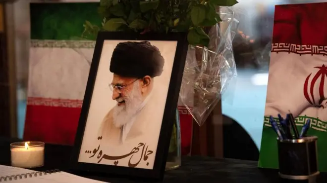 Hoton marigayi jagoran addinin Iran, Ayatollah Ali Khamenei a gefe guda kuma tutar ƙasar ce. An ajiye su ne a wani masallaci a birnin Cape Town, inda ake zuwa domin ta'aziyya. 
