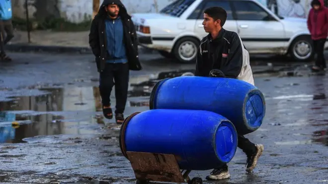 Palestinians wait in line to receive water aid provided by United Nations via mobile depots as the infrastructure for water supplies was damaged in Israeli attacks in Rafah, Gaza on 29 January, 2024