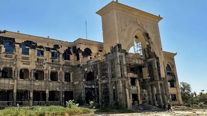 The blackened shell of the presidential palace in Khartoum, Sudan March 2025