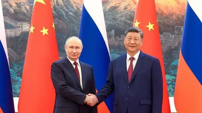 Vladimir Putin y XI Jinping se dan la mano duranre su encuentro en Pekín el 20 de mayo de 2026