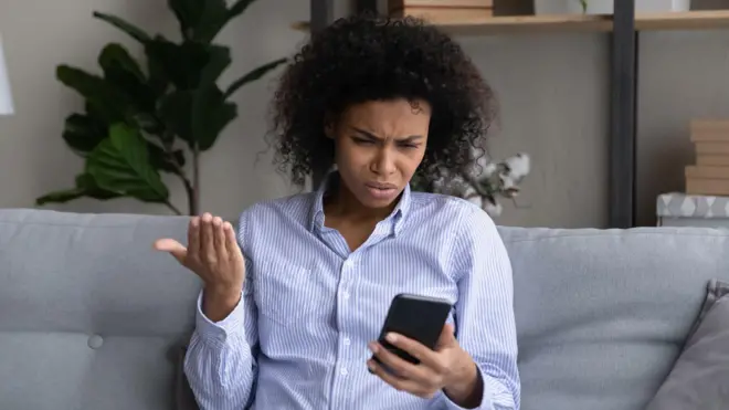 Woman dey wonder as she dey check her phone