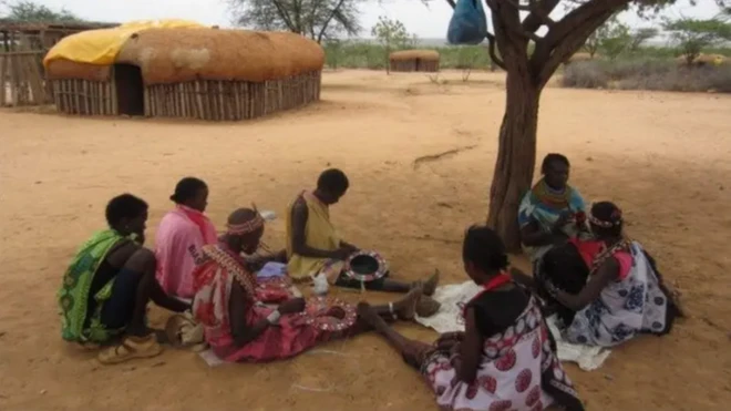 Awọn obinrin jokoo si abẹ igi 