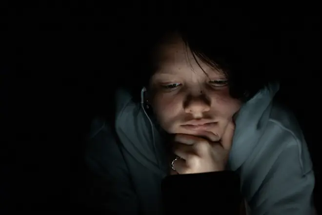 A girl reading news through phone 