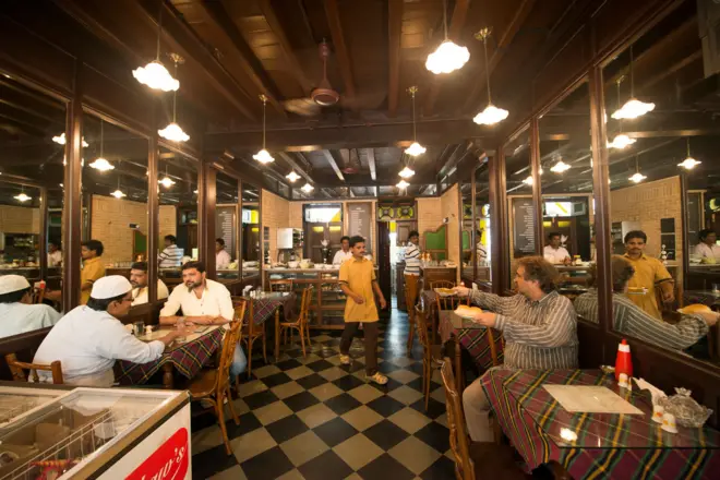 چند نفر در یک کافه پارسی در هند نشستهاند و چای مینوشند