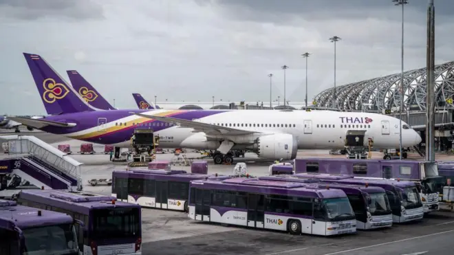 2022/08/12: A Thai Airways (TG) Airbus A330 is parked around transit buses outside a departure gate at Suvarnabhumi International Airport (BKK)