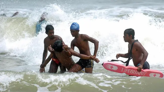 Sri Lankan lifesavers who have been trained by Japanese Red Cross officials, take part in a training exercise on a beach at Negombo