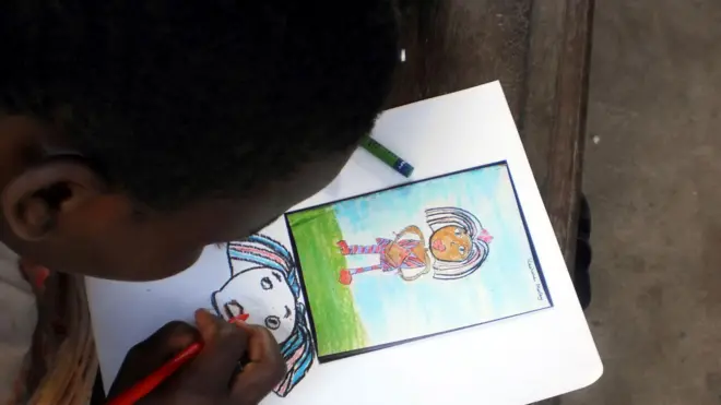 Young girl dey draw