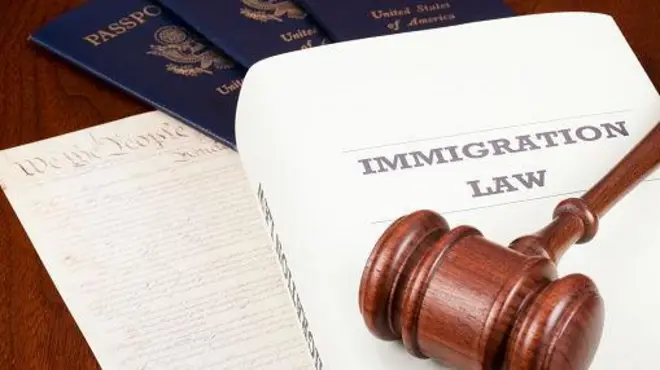 Foto of gavel and US passport wit text of immigration law