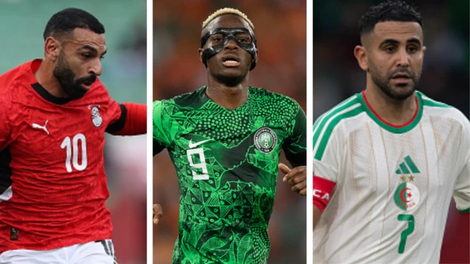 Mohamed Salah of Egypt wear dia national jersey, red shirt and white shorts wey get black design, di red shirt get black design for di neck and number wey dem write wit white colour. Victor Osimhen of Nigeria wit mask for face, wear di flowered green national shirt wit black design and di number 9 wey dem write wit white colour, Riyad Mahrez of Algeria wear dia national white jersey wit a touch of green stripes im wear red captain band and di number 7 dey for green colour
