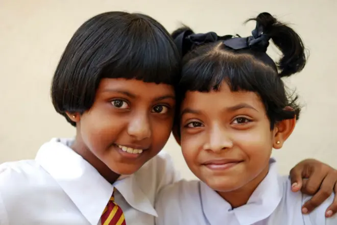 ri Lanka, Colombo, portrait of 2 smiling schoolgirls