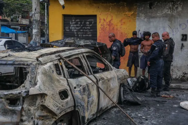 Police officers and residents during operation in Rio