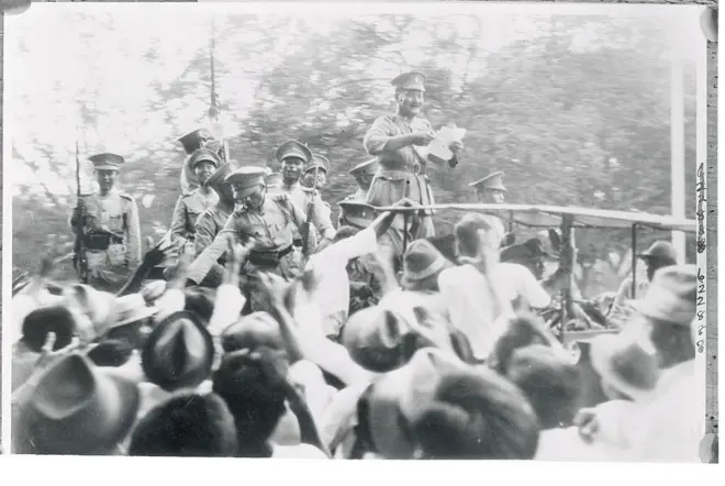 Reading 'Death Warrent' of Siam's Absolute Monarchy
Siamese Army official reading the people's party manifesto that spelled the doom of Siam's traditional absolute monarchy, one of the last to withstand the wave of post-war reform. Note the pleased expressions of the other Army officers who represent a large sector of the Army that combined with the Navy to bring about the 'peaceful' revolution curtailing the powers of the King Prajadkipok. Soldiers and sailors paraded through the streets announcing the change of Government.