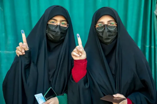 Iranian woman shows their ink-stained finger after casting her ballot for 12th term of the parliamentary elections and the 6th term of the Assembly of Leadership Experts at a polling station on March 01, 2024 in Tehran, Iran. 