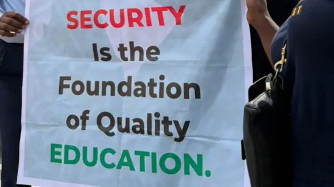 Teachers carry placards to protest school pupils and teachers kidnap
