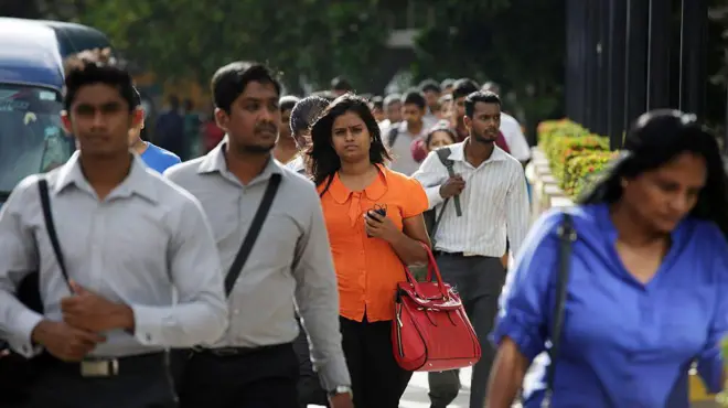 Morning commuters walk outside the Colombo World Trade Center in the central business district of Colombo, Sri Lanka,