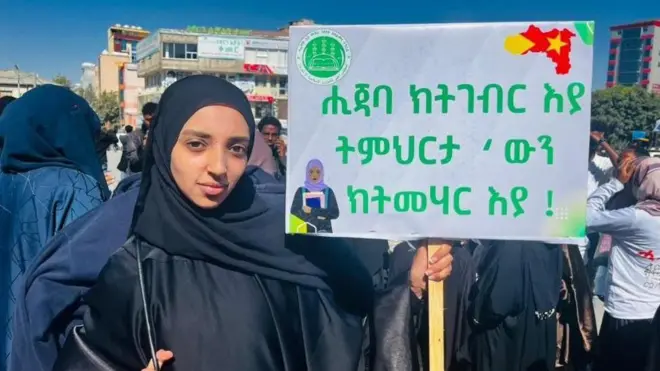 Gabadh mudahaaradaysa oo sidata boodh ay ku qoran tahay "Waxay xidhataa xijaabka waxna way baranaysaa" intii uu socday mudaaharaad ka dhacay magaalada Mekele.