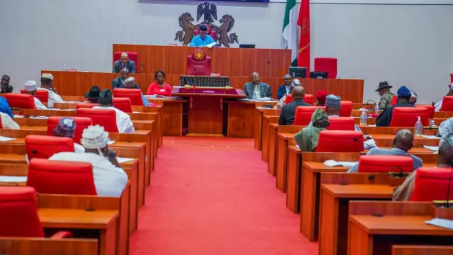 Plenary sitting of the Nigerian Senate in session led by Senate President Godswill Akpabio in blue kaftan and cap