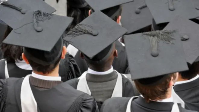 Students wear graduation gown