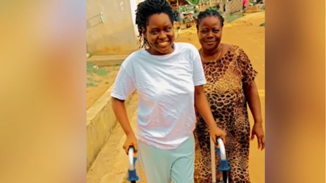 Two women wit smile for dia faces while one wey wear white shirt dey hold crutches