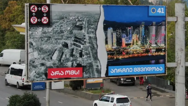 An election banner in Georgia contrasts peace in the country with devastation in Ukraine