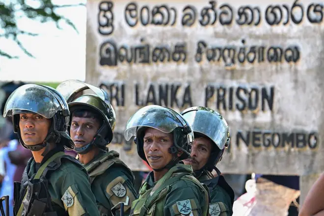 Sri Lanka's elite army personnel stand guard outside the Negombo prison near Colombo on July 6, 2026 following overnight clashes between inmates and guards. Clashes in a Sri Lankan jail have killed 23 people, including four guards, and wounded more than 100 in the country's deadliest prison riot in more than five years, officials said July 6. (Photo by Ishara S. KODIKARA / AFP via Getty Images)