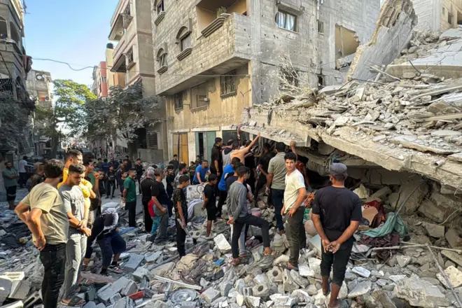 Hombres cerca de un edificio en ruinas en Beit Lahia.