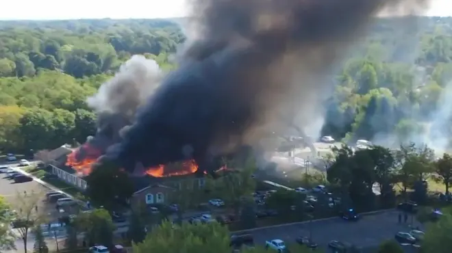 Aerial view of the church building complex on fire. 