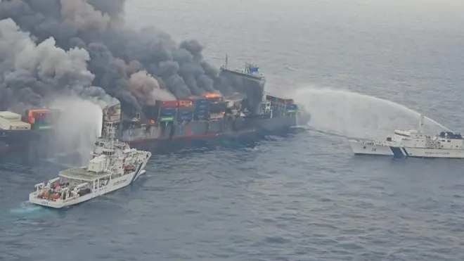 Indian Coast guard vessels seen spraying water to douse the fire on the Singaporean vessel MV Wan Hai 503
