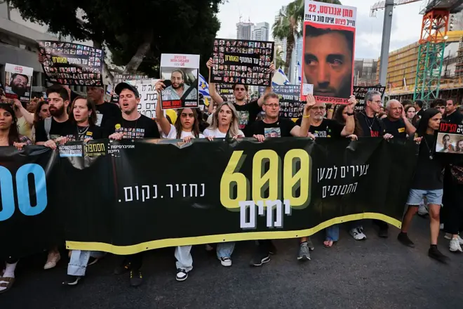 Relatives and supporters of Israeli hostages held captive in the Gaza Strip since October 7 hold their portraits during a protest at Hostages Square in Tel Aviv on 28 May 2025.