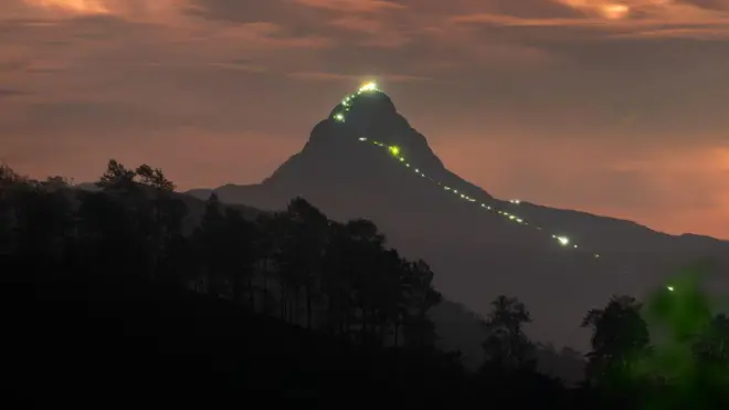 A bulb-light path and general view of the Adam's Peak mountain in Hatton, Sri Lanka, on April 22, 2023