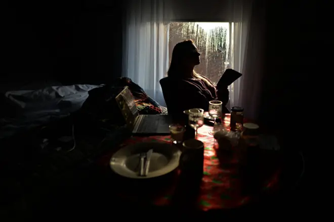 A woman looking at her cell phone in a Dublin apartment during Level 5 Covid-19 lockdown. The Department of Health reported this evening a new daily record of 3,394 new Covid-19 cases for the Republic of Ireland (previous record of 1,753 cases as of January 1, 2020). On Saturday, January 2, 2020, in Dublin, Ireland. (Photo by Artur Widak/NurPhoto via Getty Images)