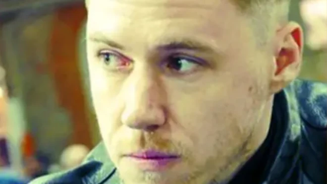 A close-up image of the alleged Russian spy Sergey Cherkasov looking pensive with blonde, spiky hair and stubble.