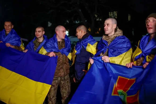 Украјински војници заогрнути заставама земље након што су размењени