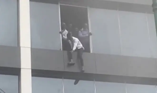 Man jumping window of Afriland building