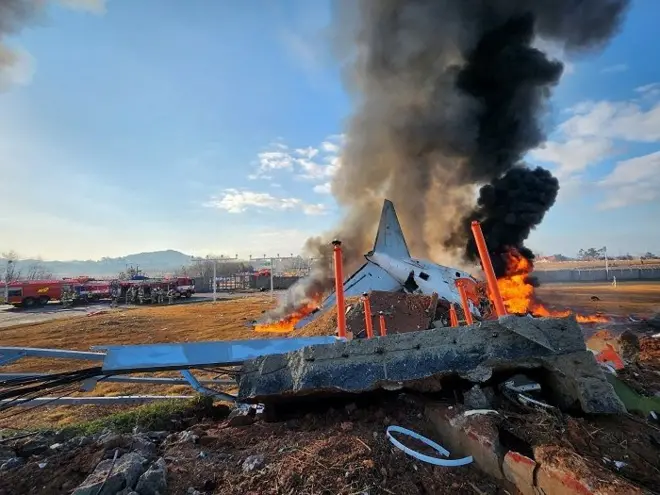 Firefighters carry out extinguishing operations on an aircraft which drove off runaway at Muan International Airport in Muan, South Jeolla Province, South Korea, December 29, 2024.
