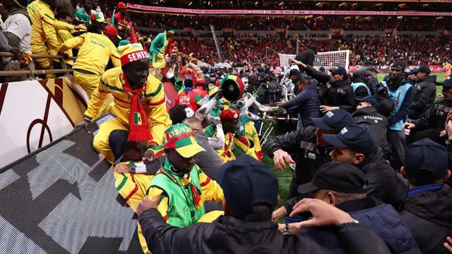 Security personnel block angry fans over a penalty decision against Senegal during the Africa Cup of Nations final