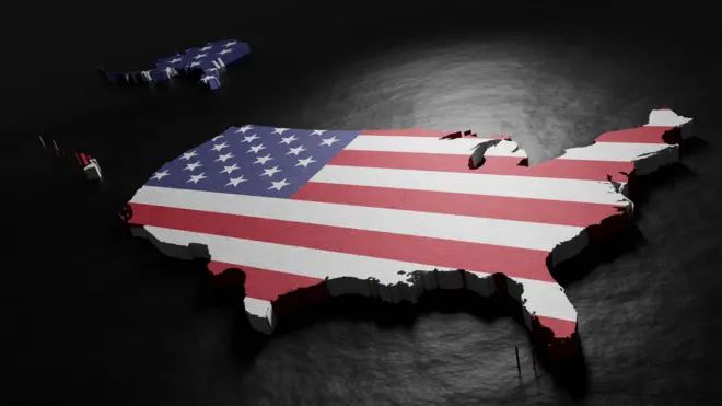 3D cutout image of the US territories highlighted with the flag of the United States.