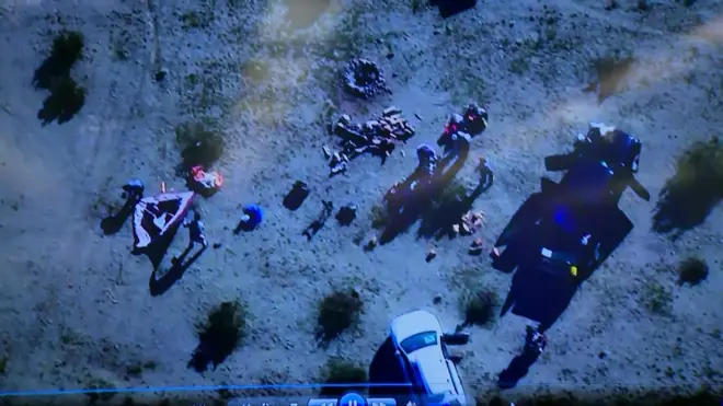 Aerial footage showing a group of people moving materials allegedly used to test explosives in a California desert.